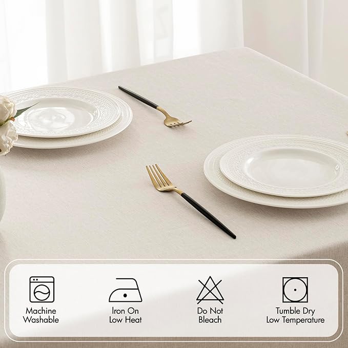 Beige rectangular linen-polyester blend tablecloth with decorative cutwork pattern, waterproof, stain-resistant, and shrink-resistant, measuring 52x70 inches.  Farmhouse style, suitable for dining rooms, weddings, parties, and outdoor picnics.